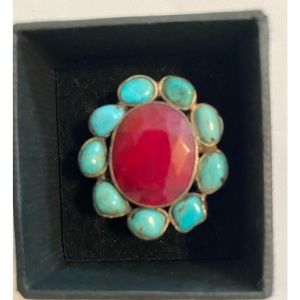 Beautiful polished red stone surrounded by turquoise stones in sterling silver